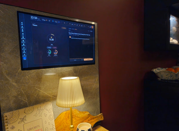 Wall mounted kitchen tablet running a custom Home Assistant dashboard with cooking timers and a recipe view
